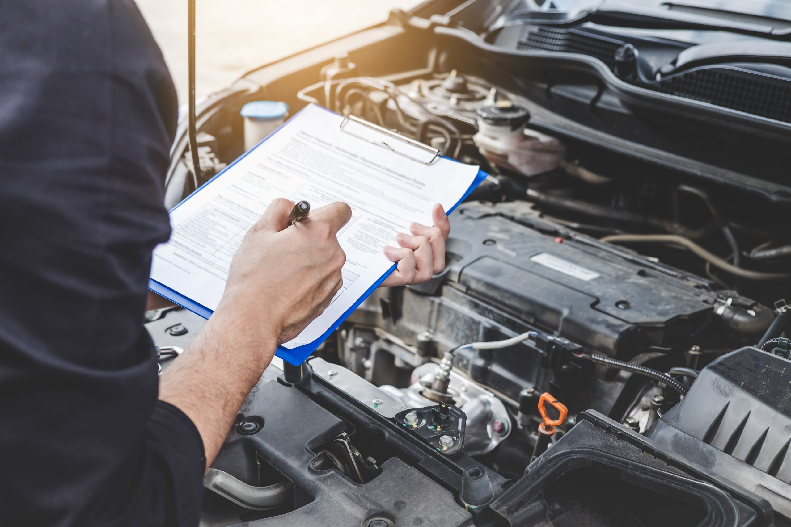 GMC service inspection being done by a woman for GMC SUV engine