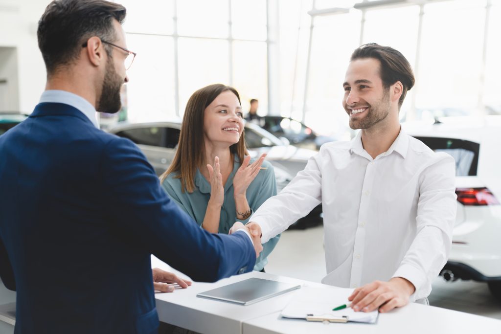 Finance specialist assisting a customer couple in the GMC showroom