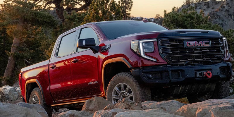 2026 GMC Sierra 1500 AT4 driving on an off-road trail