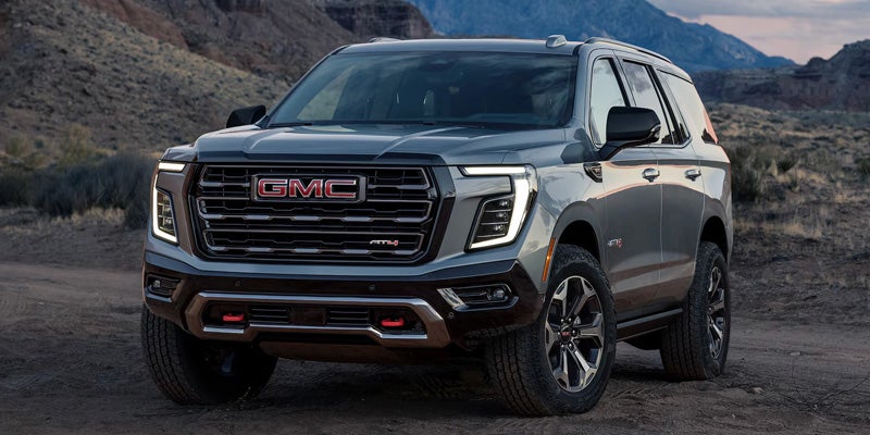 GMC Yukon XL parked on a rugged, rocky trail.